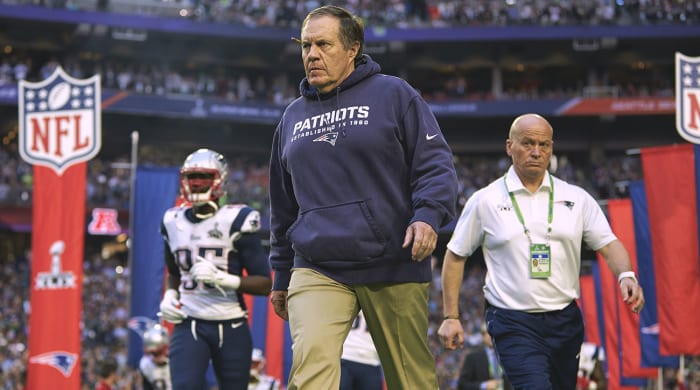 Bill Belichick walks onto the field before Super Bowl XLIX